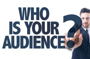 Business man pointing the text: Who Is Your Audience?
